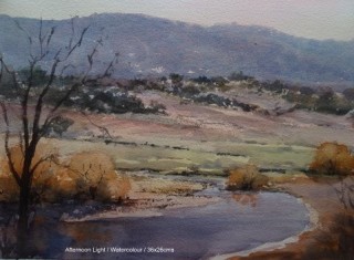 A Watercolour painting by Lesley Whitten in the Realist style  depicting Landscape Mountains River and Rural with main colour being Blue Green and Grey and titled Afternoon Light