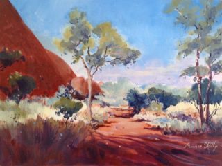 An Acrylic painting by Annee Kelly in the Impressionist style  depicting Landscape Outback Rocks and Trees with main colour being Blue Brown and Ochre and titled Mystical Land, NT